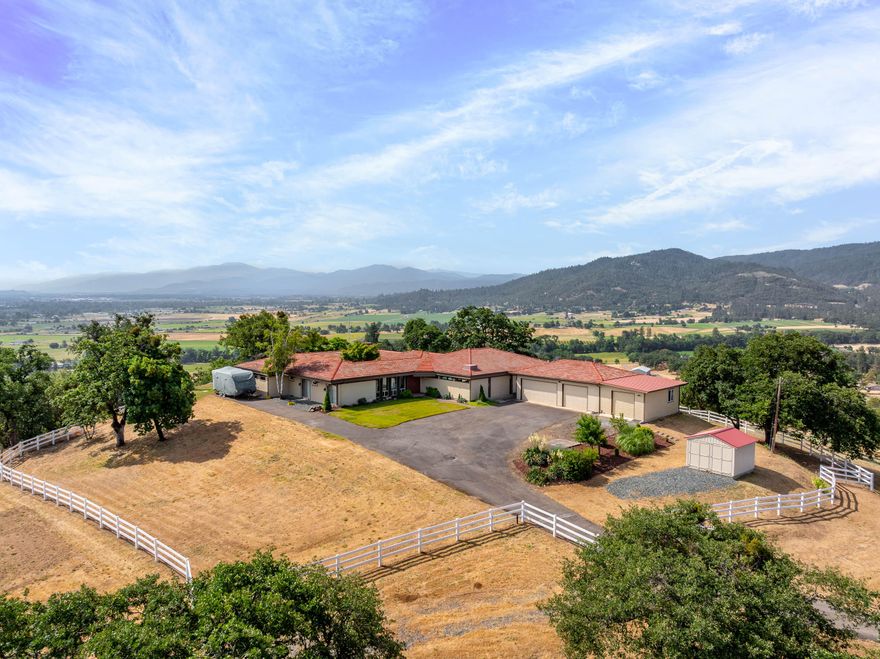 Mid-century modern elegance perched atop 20.36 private acres with breathtaking mountain and valley views!This stunning 4-bedroom,4-bath home features clean architectural lines,a unique indoor atrium that brings the outdoors in.The spacious kitchen has upgraded Thermador appliances and a view of the patio and pool so you don't miss the fun while cooking! The open living area is perfect for entertaining, flowing seamlessly to an incredible outdoor space with an inground pool, outdoor kitchen and spacious patio-deck. The luxurious primary suite offers a jetted tub, walk-in stone shower, dual vanities and a generous walk-in closet. The 1424 SqFt,  3 car finished garage with 3 phase power and added separate storage space will meet all  your storage and car needs.  With abundant RV parking and ultimate privacy, this one-of-a-kind property blends sophistication,comfort and natural beauty-your own mountain-top retreat awaits!
