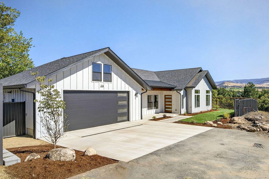 Welcome to Ash Meadows, a new 4 lot subdivision in Ashland Or. This rare find has two homes on one lot, each single level with lovely views of the E hills. The main home features 2019 sq feet, 3 bedroom and two and half baths, with easy access to Downtown Ashland. Its open design includes a spacious island kitchen with quartz countertops and backsplash and stunning great room design featuring a floor to ceiling fireplace and 9 foot ceilings throughout. The primary suite is a retreat with a spa-like bath, soaking tub, walk-in shower, dual vanity and skylight. A large slider extends living to a tongue and groove covered patio landscaped and fenced yard  The second home adds 1,188 sq ft with 2 bedrooms and 2 baths, remodeled with quartz counters, new cabinetry, and updated systems ideal for extended family, rental income, or guests offering a unique opportunity!