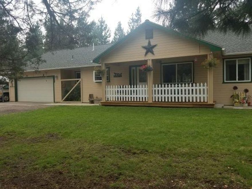 Homes shows very well. Brand new carpet throughout. Very nice updated kitchen with all appliances. Big covered deck with a hot tub. Darling porch on front of the home to sit and watch all the wildlife. Huge 30 X 36 shop with 8ft and 10 ft doors that is heated. 24 X 36 pole barn for hay and horses. Very nicely landscaped with natural settings. There is a closet space that has been setup that someone could add a half bath.