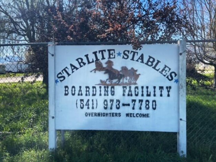 Nestled between Medford and Phoenix, Starlite Stables offers an idyllic setting for horse enthusiasts. This 18-stall turn-key horse boarding facility has panoramic views. All level, usable land w/ 4.66 ac of irrigation rights from Medford Irrigation District. With EFU zoning this farm land has many uses & with it's current use boarding horses, has a well established clientele for over a decade. The main barn has 14 stalls w/ automatic waterers & large paddocks. Paddocks have automated water misters keeping the air cooler in the summer months. Adjacent to the main barn is a 6-stall mare motel. The facility is complete w/ an outdoor arena, round pen and a dedicated horse wash station w/ hot & cold water. Ample room for horse trailers along w/ a well constructed multi-use covered carport. The round pen is perfect for exercise while pastures are ready for grazing. Property has electric fencing, cross fencing & a horse obstacle course. Good producing well ensures for a steady water supply.