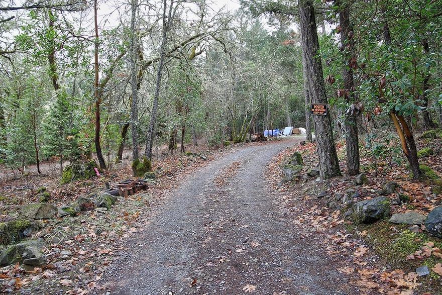 Lovely and Beautiful 2.91 Acres of Rural Property in the Applegate Valley! This Property is set at the end of a Quiet Dead-End Country Road, backs to BLM, and has an Existing Well and Septic. The Property does have a 1971 Double-Wide in Poor Condition, as well as Numerous Outbuildings and Sheds. And quite a bit of Debris. The Setting here is Quiet and Peaceful, away from any and all Busy Roads. The Main Value of this Property is in the Land and Existing Utilities. This is a Fantastic Location to Build a New Home or place a New Manufactured Home. Well and Septic, and Power and Telephone are on-site and ready to go! This Property is in an Estate and being Sold 'As-is', with ALL Personal Property included. Meaning when you buy this one, you get the good with the bad. Don't overlook this one based on the Debris on the Property; it is Beautiful Land in a Great Location!