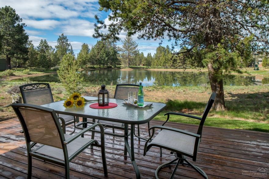 Rare opportunity to own this custom built home lovingly maintained by the original owners & lightly used. Breathtaking pond views & the 8th fairway of Woodlands GC in the distance. Great room w/ see through wood burning gas fireplace. Kitchen w/ Center Island & eating bar. Main master suite upstairs w/ private deck. 2 guest bdrms downstairs + office/den or 4th bedroom. Tile roof, paver walkway, 2-car attached garage, huge deck overlooking pond. A/C Never rented. SHARC paid in full!