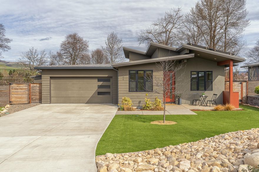 Beautiful, single-level, custom home on a level lot, with abundant & gorgeous outdoor spaces in a wonderful neighborhood. Conveniently located close to downtown Ashland's restaurants, theaters, & shops. The open floor plan offers beautiful light throughout, 3 bedrooms, an office & 2 baths, with attached 2-car garage. Plus a 48 sf. storage shed. The Great Room enjoys a Full view electric fireplace & huge pastoral views of the Greenway & Cascade Mountains. The kitchen features custom birch cabinets, a breakfast bar, granite counters & a walk-in pantry. The dining area is spacious enough to seat 8. The Primary Suite has a walk-in closet & shower. A sliding patio door opens to a spacious covered patio, a gas-fueled fire pit, a bocce ball court & access to exquisite garden areas. Ashland Creek runs behind, enhancing the tranquil setting. A large covered front porch adds another sitting area to enjoy the views! Solar panels are owned, so low electric bills! A truly magical property!