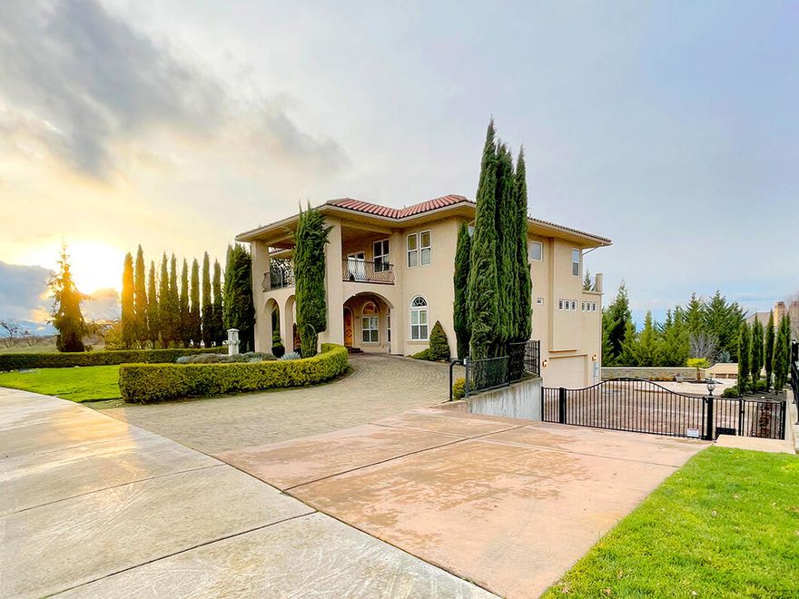 Gorgeous 3-story Tuscan-style home on 2 lots totaling .87 acre in East Medford's Saddle Ridge. Gracious formal entry opens to formal living room w/ gas fireplace and formal dining room. Continue into the 2-story great room filled with natural light, gas fireplace, travertine floors and large sliding glass doors opening to large deck overlooking pool and grounds. Gourmet kitchen is ideal for entertaining with slab granite counters, stainless steel Viking appliances, cherry cabinets and wet bar with wine cooler. Main level master suite features gas fireplace and spa-like bathroom with large shower, jetted tub, double vanities and 2 large walk-in closets. Upstairs are 3 large bedrooms, 2 full baths, family room and office complete with wet bar. Downstairs is media room and fully equipped exercise room. 4-car garage has built-in storage. Two lots (.43 acre plus additional .44 acre lot) creates privacy and park like setting. Solar-heated pool with a waterfall-wall and abundant hardscaping.