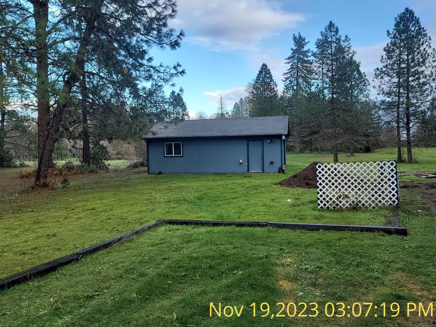 Beautiful level lightly treed in a quiet area.
The manufactured home has been moved off the property. (It was a Life Estate)
4.08 level acres with all utilities and fencing. The property backs up to year-round beautiful Slate Creek. The property includes a 2-car detached garage, 2 sheds/workshop, and a barns. It is a beautiful park-like setting with beautiful trees and green grass. The quiet setting among the beautiful semi-treed property. The property is not located on the Highway but on Old Highway 199.