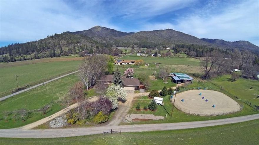 Sale fell, no fault of the property. Irrigated EUF land, well maintained 2,450' sq ft. single level home with huge master which could be a mother-in-law suite. 4.89 irrigated acres. Minutes from Jacksonville in the heart of Applegate Valley wine country. Peaceful setting w/expansive view of tree covered mountains & green valley pastures. Perfect for entertaining w/light, bright, & open living areas, spacious custom kitchen w/2 wall ovens & butler's pantry, incredible 1,500' deck w/hot tub, & 650' front porch to catch the last rays from the setting sun. Spacious master suite has a sitting area, lg changing rm & a walk-in closet. The warmth of the pellet stove invites you to come in, get cozy and stay awhile. Durable tile & laminate floors throughout. Large utility w/sink & finished storage room. Multiple use barn w/carport, hay storage, tack room, work area, & stalls. 96' outdoor arena pad & 3 large fenced & x fenced pastures. 7'x15' greenhouse & area for gard