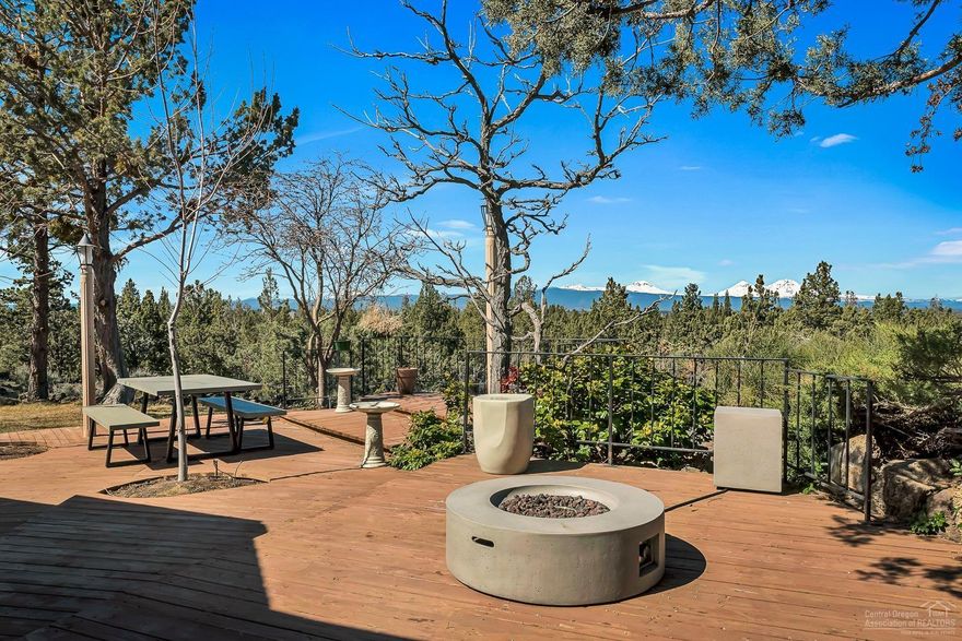 Enjoy spectacular 9 Mtn Peak Views from this one-of-a-kind private oasis on 6.58 acres. Abundant windows from the great room/kitchen showcase panoramic mountain views. Mid Century modern home offers lots of character and unique finishes including open beam/vaulted ceilings & charming wood stove w/stone hearth. Spacious master suite w/private deck. Huge back viewing deck & paver patio w/water feature. Custom stone studio for hobbies, shop w/carport & insulated storage building. New septic in 2016.