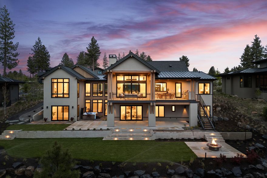 Experience refined luxury living in this stunning custom-built home in Tetherow on Bend's west side. Newly completed and thoughtfully designed, this 4,946 sq ft residence features five bedrooms—including three private suites—an office, gym and spacious bonus room. Designed for culinary enthusiasts and entertainers alike, the kitchen features Thermador appliances, beverage and wine refrigerators, a large center island and butler's pantry. The primary suite is a true retreat with a steam shower, freestanding soaking tub, radiant heated flooring, and a large walk-in closet. Enjoy seamless indoor-outdoor living with a welcoming front courtyard and glass doors that open to a sprawling covered deck with built-in BBQ and outdoor heaters, all overlooking a terraced backyard and open space. The oversized garage features epoxy floors and a tall bay door, ideal for larger vehicles. Accompanied by supreme privacy, this peaceful haven blends elegance, comfort, and access to world-class amenities.