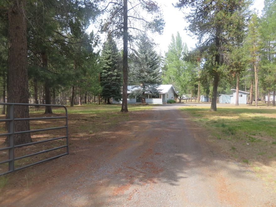 Located on 1.15 acres, this single level frame built home features 1590 SF, 3 bedrooms, 1.5 baths, large living and kitchen areas, 400 SF partial basement, carport and numerous sheds and barn/shop.  Home sits back on property offering a private setting.