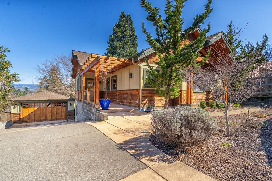 Beautifully designed custom home, with stunning Grizzly Peak views! Perfectly located, just a few minutes to Ashland's shops, theater and restaurants. The home offers incredible attention to detail, beautiful light, and is finely crafted throughout, with vaulted, timbered ceilings, gorgeous plaster walls, clerestory and Anderson windows, gas fireplace, and gleaming wood floors. Convenient, main level living with a Primary Suite, Luxurious bath, plus an office on this level. The chef's kitchen provides 2 ovens, an island gas range and a wine cooler. The lower-level includes 2 bedrooms, a bath, and a fabulous home theatre with sound attenuation, professional-quality surround sound and a wet bar. Enjoy delightful outdoor living with a charming garden, a water feature and a spacious deck. So much to love!