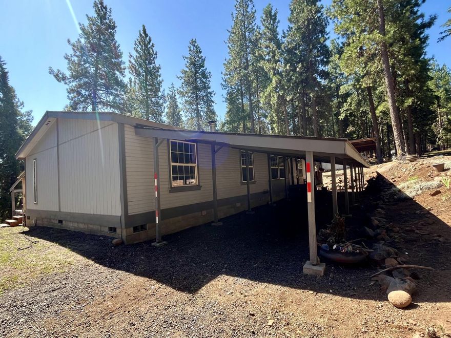 Tucked among the pines, this 3-bedroom, 2-bathroom manufactured home sits on 2.58 acres of usable land—ideal for 4-H projects, horses, and outdoor living. The home offers 1,512 sq ft of space with a functional layout, a wood deck out back, and room to make it your own. While it needs a little TLC, the bones are solid, and the potential is big. Features: Spacious living area with plenty of natural light. Detached 2-car garage for parking or storage. Additional barn for animals, tools, or equipment. Quiet, rural setting perfect for outdoor recreation. Located just 20 minutes from downtown Klamath Falls, this property gives you the privacy of country living with city convenience close by. Priced to reflect condition — a great opportunity to build equity in a beautiful setting.