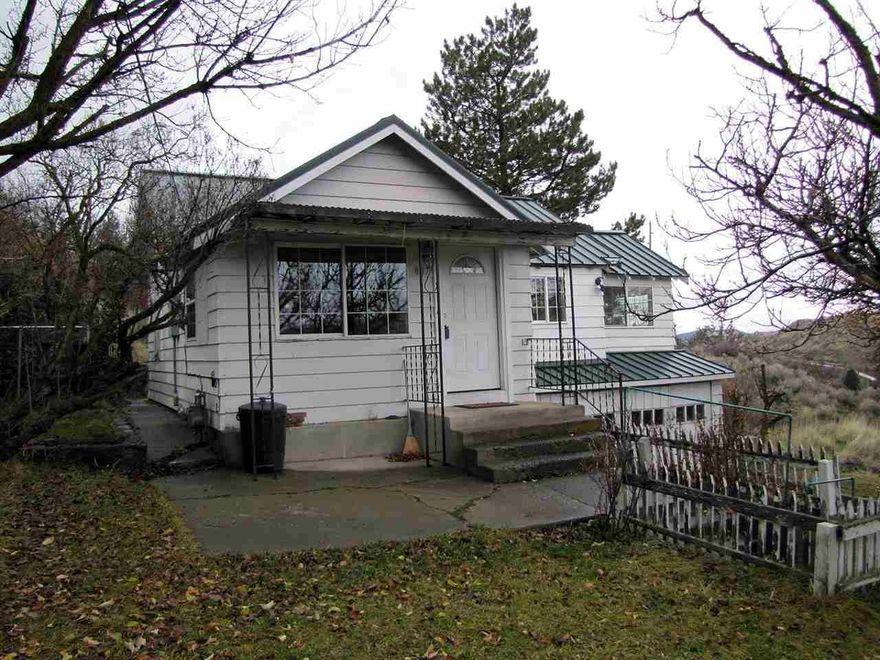 This Little Home Has Been Upgraded Through Out The Interior. Laminate Flooring, Solid Surface Counter Tops, Integral Sink Mount, New Toilet, Stainless Steel Appliances And Metal Roof. The Location Provides A Fabulous Lake And River View With Easy Access To Downtown Shopping And Entertainment. This Home Is Being Sold In as Is Condition And Would Make A Great Little Investors House For Rent Or For Sale. Lots Of Fruit Trees In Back And Front Yards With Wonderful Mature Landscaping.