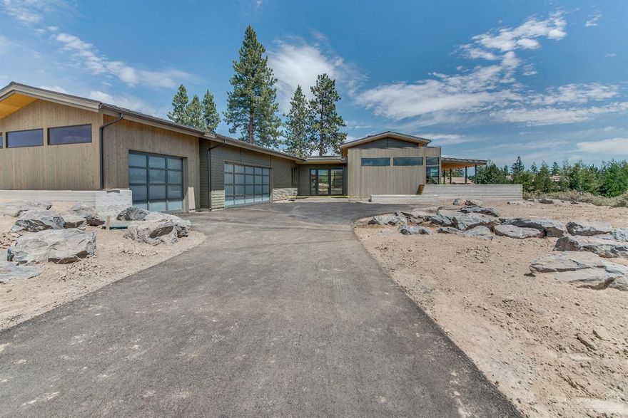 Construction well underway! Ready for June move-in! A collaboration between Design Haus and Bend Trend Homes brings this stunning single level NW contemporary design to the sought-after Tetherow community. The efficient design is open and flowing with loads of light, accordion glass walls, top of line finishes and features, three suites, office/flex space. Exterior living space is paramount in this home with courtyard and covered terraces. Some interior photos are of similar completed homes.