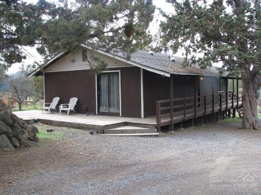 Cute single-level situated just down a country lane close to town, shopping, convenient to Sisters-Tumalo. Open living area w/ island kitchen, sliding glass doors onto raised deck. 3 bedrooms, 1 bath, detached garage w/ attached garden shed, accessed from circular gravel drive. Nice rock out-cropping gives privacy from street. Some improvements have been done which add to the appeal.