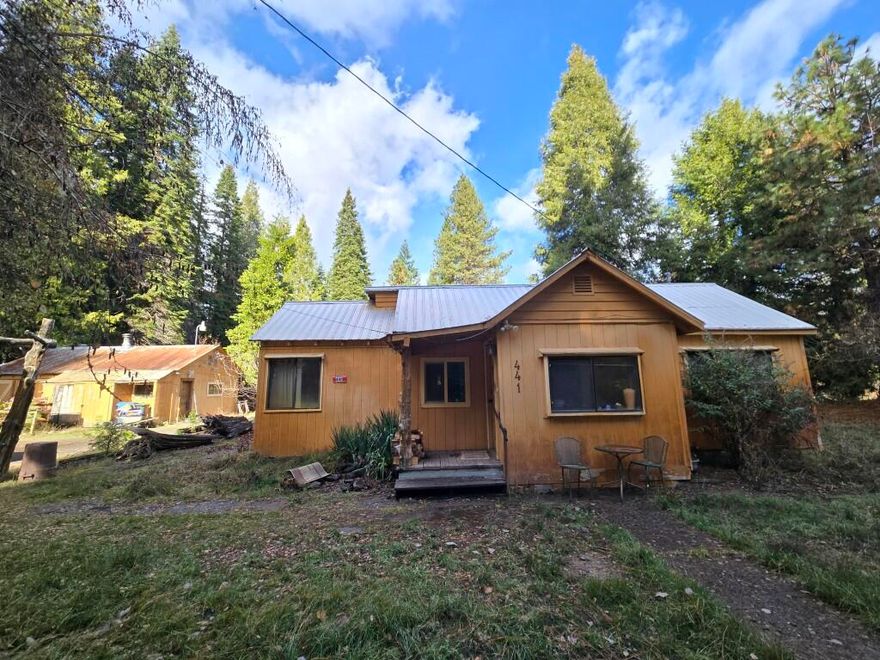 3Bdr/1Bth on 3 beautiful flat acres. 1297 SF., nice kitchen, rich wood cabinets, vinyl floor, double pane windows, garden window, laundry room, ceiling fans, water filter in kitchen, bathroom and at pump, good well per seller, wood stove, large shop with 220, storage building, garden area or dog run. RV or boat awning,, storage with room for small boat, lots of sugar pine, cedar Douglas fir trees, and an apple tree.