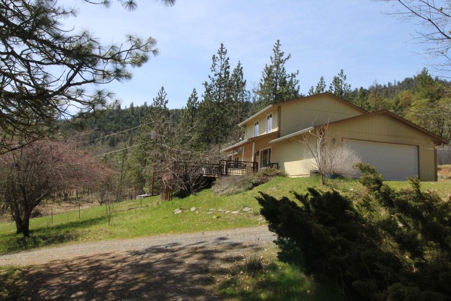 Come to the warm and sunny Applegate Valley. This home sits on 4.82 all usable acres. Privately situated 2 story home w/ mountain & valley views. 3 bd, 2 bth w/ bonus room.  2 bedrooms and a bath on the main level, primary suite upstairs w/ separate office. Home has been freshly painted on the interior w/new appliances,  bamboo and tile flooring. The gently slopping land has many uses, fenced for gardens and animals. There is a a work shop and 30 X 90 greenhouse for the green thumb in the family. A capped  well is located on this property & a good producing well on neighbors to the East that is shared with this property. 2000 gal water storage tank provides enough water for all the household and gardening needs. A seasonal creek surfaces during the wet season. Property is backed by BLM land for endless exploration.