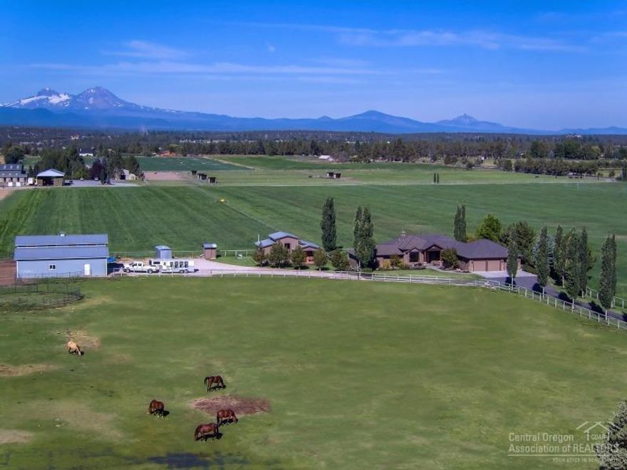Cascade Mountain views from Ranch style home: 3112 sf, 3 bedroom, 3.5 bathroom, open floor plan, living room with gas fireplace, wood floors, office, piano room, master suite with tub, deck and attached 3 car garage. Landscaped yard with sprinkler system and detached studio/office. Property is 41 acres with 39 acres of irrigation water rights used for hay, livestock grazing. Property includes: barn, garden area, fenced, cross fenced, gated and paved driveway. Terrific location minutes from Bend or Redmond!