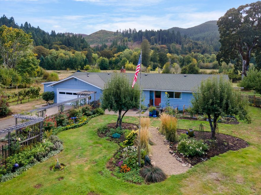 Discover a stunning 33-acre estate nestled alongside a picturesque river. This meticulously maintained 1,610 square foot residence boasts exquisite craftsmanship and is conveniently located just minutes from town. The main house offers ample space with 4 bedrooms and 2 baths, while an additional 2 bedrooms in the Accessory Dwelling Unit (ADU) provide flexibility and comfort. This welcoming home is tailored to meet your family's needs, offering room to explore, a private riverfront beach, and plenty of space for your beloved animals. Multiple well-maintained outbuildings ready for your creative use, along with the advantage of 3-phase power at the river's edge. With its layout, this property lends itself to multi-family living.  Conveniently positioned near Fern Ridge Reservoir and just under an hour from the beach, this location allows you to explore in all directions. Soak in the tranquility from your back patio, where you can observe the abundant wildlife!