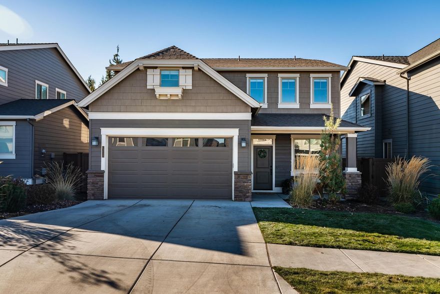 Welcome home to this beautiful Pahlisch home in McCall Landing. Featuring durable laminate wood floors throughout the main level, quartz counters in the kitchen, large windows overlooking the backyard and main-level office/den, this home has all the spaces you're looking for. Upstairs, you'll find 3 bedrooms, including a spacious ensuite with double vanity and large soaking tub. Also upstairs is a large bonus room with a  closet so big it can be another room! A landscaped backyard, covered patio, and oversized garage rounds out this well-maintained home. The quiet neighborhood provides front yard landscaping, a community park, and is less than a 10 minutes drive to downtown Bend.