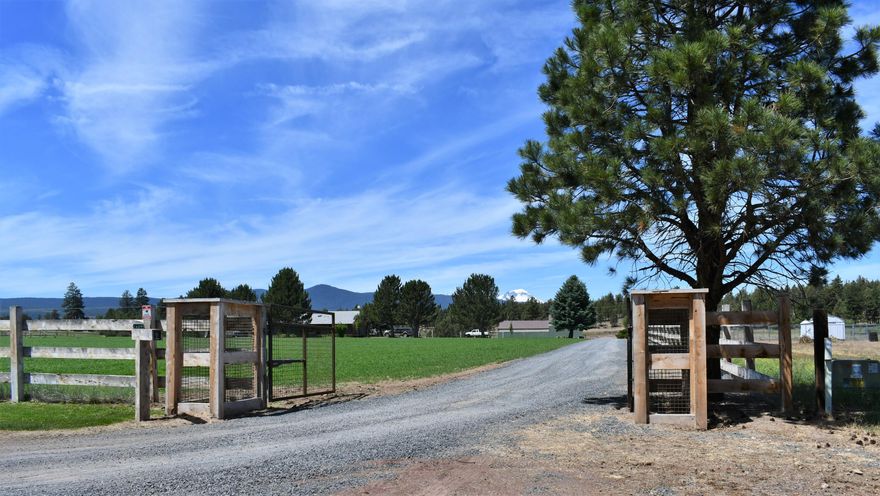 Premier gated Tumalo Ranch location close to Tumalo Reservoir with majestic Cascade Mtn Views.
Find your peace and serenity at this very private ranch yet 15 minutes to Bend.  Excellent area for horses, livestock, agriculture farming & trails. Views abound in every direction: Large Pond, natural pines, overflow creek & Deschutes forest w/trails.  Classic 1656 sq ft ranch style home on 11.86 acres includes, front deck, fenced meticulously maintained pastures, large pond, 11 acres of irrigation, fencing, temperature-regulated greenhouse, private well, 3192 sq ft shop with 6'' thick concrete floors, 3 barn doors, 9'2'', 9'2'' and 13'7'', 30' x 60' storage room for your shop/office. The backside of the barn is set up to store hay, RVs, boats, ATV's & parking. Enjoy the ever-flowing Bear Springs Creek that runs in the SW corner. Bonus room off the garage with bath & private entrance. Ample space to expand the existing home or build a new. Options are only limited to your imagination!