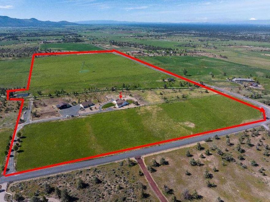 Situated on 94.69 acres this farm is well laid out and turnkey. With stunning Cascade Mountain and Smith Rock views this custom home offers an open floor plan and comfortable spacious living. Step inside and you will find a formal dining room, a great room with a fireplace, large breakfast nook complete with a window seat and a kitchen that is a delight with its 10 ft island, quartz countertops, 6 burner propane stove, double ovens, pantry and an abundance of cabinets. The primary suite has a soaking tub, oversized tile shower and double vanities and there are two secondary bedrooms. You'll also find an office/media room offering great space and a laundry room that will amaze you with its size, cabinets and storage. 2880 sqft insulated shop with guest quarters, RV hookups, 2 hay barns, pipe alleyways/corrals. 79 acres of COI water rights, 2 gps pivots, pods for front field & a large pond. Excellent location, great set-up and a first-rate farm. Currently in pasture & cattle grazing.