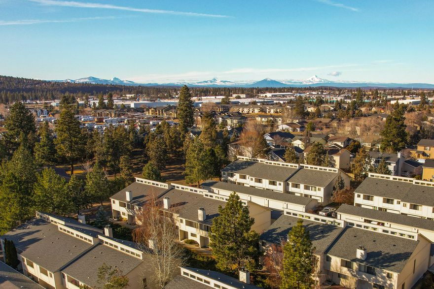 Quit paying rent and invest in your own home! Or as an investor, take advantage of the affordable pricing. Two master suites at each end of the upstairs with full bathrooms (tub & shower separate). Open floor plan, vaulted ceilings, an island in the kitchen, wood burning fireplace in living room for additional heat or ambience. Storage galore. Front & back porches for barbecuing or just relaxing in the Central Oregon sunshine. HOA dues cover water, sewer, garbage & also the luxury of having a swimming pool, clubhouse, tennis courts and even a dog park! All of this is located in a reputable complex conveniently located in NE Bend.