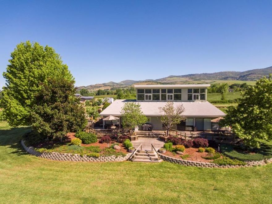 Endless possibilities for this one of a kind Ashland estate! EFU zoning keeps taxes low and TID keeps the pastures green. Includes two adjoining 4.97 acre parcels being sold together. Both are EFU with TID irrigation, and are flat and usable. You will find beautiful mature landscaping around the home with a small raised bed vegetable garden that has more than enough room to expand. The remainder of the pasture land is currently being used for grazing horses. Built in 1981 this passive solar home was ahead of its time, and has been meticulously cared for throughout the years. The two story home has all the bedrooms and two full baths up stairs, with the living space, office, laundry and a full bathroom down stairs. You will enjoy views of Mt Ashland and the surrounding valley from any point on the property. Plenty of space for tools, toys, and cars in the 3 car garage. Also the property has enough outside parking space to accommodate your RV, and its only 5 minutes to downtown Ashland