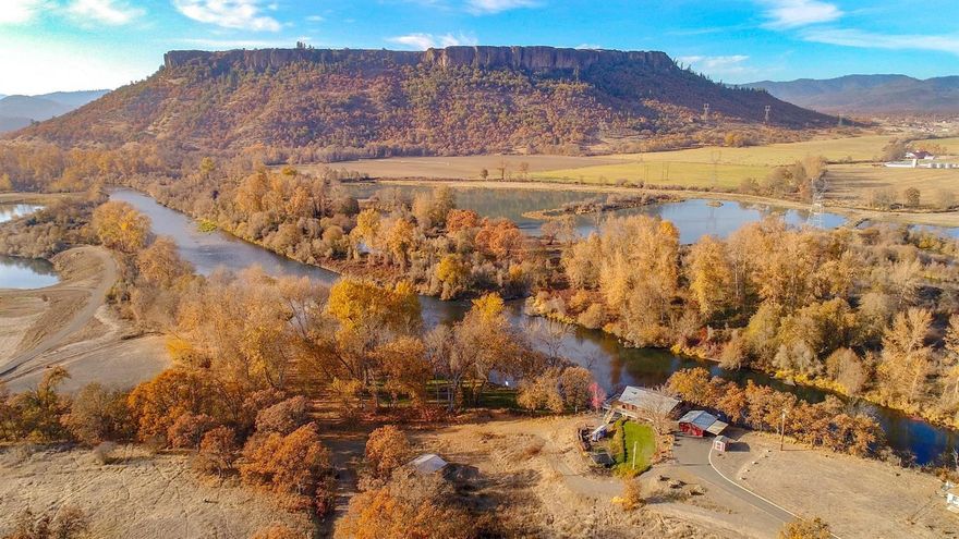 This 8.55 acre property is nestled along BOTH sides of a rare and breathtakingly scenic stretch of the acclaimed Rogue River, presenting unsurpassed privacy and views of Table Rock. The 2501 Square foot 3 Bed, 2.5 Bath rustic home was strategically built perched on a knoll above the floodplain to look directly over the river, boasting views over a quarter mile down stream. Additional amenities include a private boat launch and a large flat irrigated recreation area, developed with underground sprinklers, an extravagant fire pit and lighting to enjoy evenings by the river or long summer days fishing or gatherings shaded by a series of mature cottonwood trees. This property is truly one of a kind!