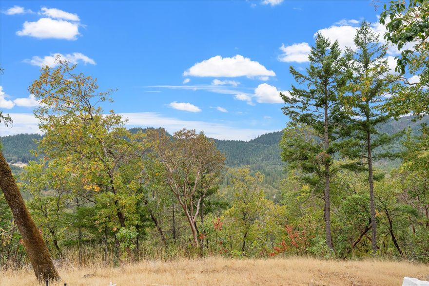 45+ acres with intoxicating views and a cleared pad, ready for new construction! Nestled in the picturesque rolling hills of rural Grants Pass, this property offers exceptional nature views and an abundance of privacy. The approximately 200' diameter clearing (which previously had a manufactured home) offers a mostly level surface. The site may be ideal for a new manufactured home or a brand-new dream home! An additional clearing offers the opportunity to build a barn, shop, or space to relax and take in the views. The location is less than 3-miles from I-5, making it the perfect location to feel far away with the convenience of an easy commute or trip to town.