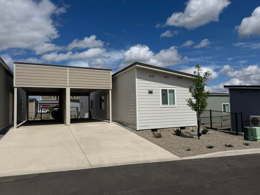 Welcome to your beautiful modular home, built in 2025, nestled in an all-ages park that offers both comfort & community. Featuring a stunning metal roof & durable vinyl plank flooring throughout. Boasting an open kitchen w all appliances included. Stay comfortable year-round w heating & AC mini-splits in each bedroom & the great room. The north-facing fully fenced backyard provides a shaded retreat, ideal for relaxing on warm sunny days. Plus, w a convenient carport, you'll never have to worry about parking. For just $700 per month, your park rent covers water, sewer, garbage, & gives you access to an amazing new kids' playground & clubhouse. This fantastic feature makes it easy to keep your little ones entertained while fostering a sense of community w your neighbors. Located just a short drive from restaurants, shopping, & freeway access, everything you need is right at your fingertips. Don't miss out on this incredible opportunity to own a lovely home in a vibrant community.