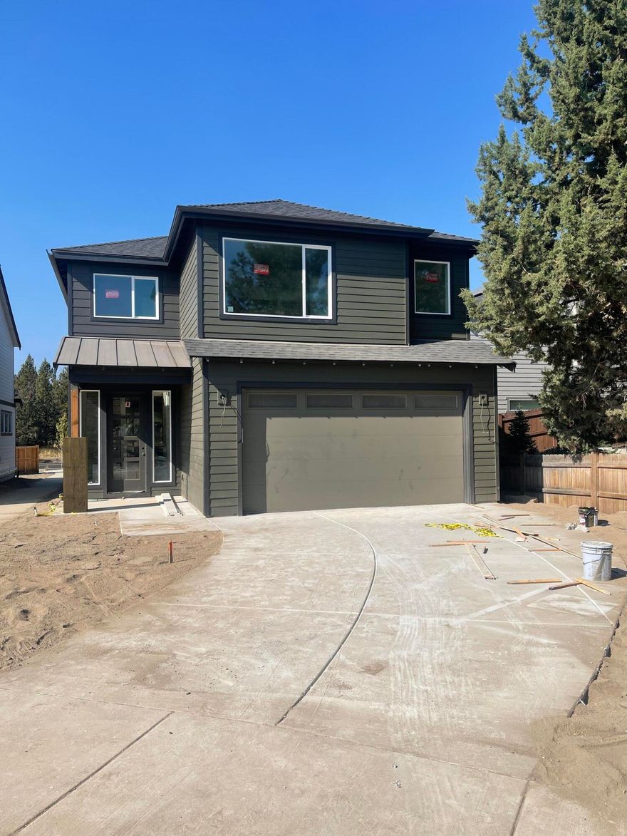 When you visit this stunning home by Stone Bridge Homes NW in Bend's newest NW Bend neighborhood North 44, you will want to move right in. This home features an open floor plan perfect for entertaining.  The kitchen and great room are light and bright with hardwood flooring, stainless appliances, and quartz countertops and a gas fireplace with floor to ceiling tile surround. The second level has 3 bedrooms and a bonus room. The owner's suite features an oversized walk in closet, soaking tub and double vanities. This home comes equipped with A/C, fencing and full front and back yard landscape, is Earth Advantage certified, including energy efficient features such as a tank-less water heater, wiring for  a 220 & 110 plug in the garage for an electric car. Buyer also receives a complimentary 2-10 home warranty.