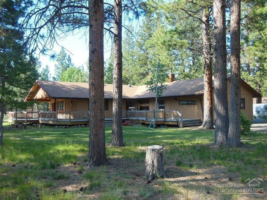 Wonderful setting in the ponderosa pines. A beautiful lot bordering National Forest.2396 Square Feet with Spacious and flexible great room layout. Cozy and comfortable living space with woodstove. Two master suites plus additional bedroom and two den/hobby/bonus rooms for special purposes. Laminate flooring though out living spaces. Lots of windows let the outdoors in while a large covered patio and ample decking supply fantastic outdoor enjoyment. Just minutes from Sisters in a quiet neighborhood.
