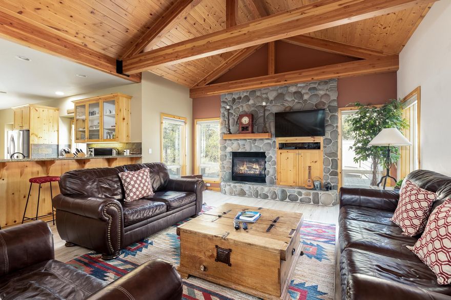 Fantastic five bedroom lodge style home in Sunriver's desirable North end.  New LVP floors highlight the open concept dining, kitchen, and great room that offers plenty of space to entertain.  The main level also features beautiful vaulted ceilings, two primary suites and a powder room.  Kitchen has granite counters and a gas stove top.  This home is producing great rental income.  Three car garage with plenty of space for all the necessary Central Oregon toys.  Nice outdoor living space with hot tub that backs to common area.  Three bedrooms and full bathroom upstairs, carpet was replaced in 2019.  This home has A/C and comes fully furnished, including TV's in every room and plenty of family games.