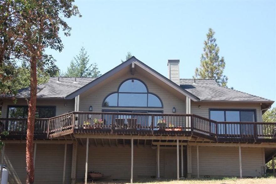 Stunning views in this beautiful turnkey home. Newly updated with all new fixtures, sinks, comfort toilets, well pump, water softener, water heater, and heat/AC unit. An abundance of floor to ceiling windows allows you take in the views of McLoughlin, Table Rocks, and the Rim of Crater Lake. The living room has a cozy fireplace and floor to ceiling windows with sliders out to the deck. The kitchen is open to the living room with all new top of the line stainless appliances. Two master bedrooms with tile showers each have doors to the deck. Enjoy nature with easy access to the Jacksonville Woodland Trail system. This fabulous, tranquil home offers peaceful country living while being just minutes from Britt and Jacksonville's restaurants and shopping.