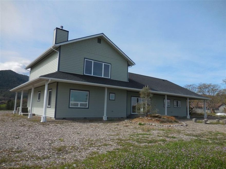 Well thought out custom home with 360 degree views of such beauty! Rolling 5.36 acres for orchard & vegetable gardens. Light and bright throughout plus solid oak hardwood and travertine floors. Handcrafted walnut breakfast bar, gas range, granite counter top, plus 2 wood stoves. Two HVAC systems for ultimate energy efficiency. The vaulted ceilings give additional sense of spaciousness throughout. Large master suite with panoramic views! You'll be at home in the country and yet just minutes from shopping and freeway. Plenty of room for guests to park in driveway and beside garage.Assessor has year built as 2015, however home was completed in 2016 Well produces 14.5 GPM per seller. Adjacent tax lot 1507 has well and septic and may be available to purchase with home. 5.15 acre flag lot.