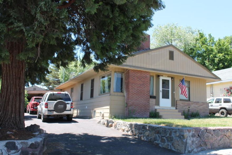 Ready to move in. 3 Bedroom 2.5 bath with HUGE basement bonus room.  Freshly painted on the outside. Original hardwood floors in the first two bedrooms and hallway.  Two large living rooms with new laminate flooring and new carpet. Formal dining room with built in hutches.  Large master bedroom. Two car garage with attached carport and lots of extra storage and workshop in the back. Alley access with extra parking behind the garage. Low maintenance landscaping. Seller is accepting back up offers.