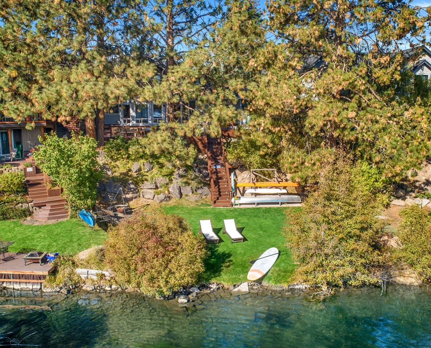 This stunning Deschutes riverfront home with easy river access is only a few blocks from the Galveston corridor and less than a mile to Old Mill or downtown Bend. Newly remodeled and expanded in 2014, the homeowners designed the home for beauty and function with interesting vaults, timeless finishes, & abundant windows for light and views. Wake up every morning feeling like you are on vacation watching the light bounce across the water through the trees. The thoughtful floor plan creates many options with 3 bedrooms & 3 bathrooms on the main level in addition to the luxurious master suite and library/office upstairs. Above the garage you will find guest quarters with a private deck, small kitchen, & full bathroom which has potential to be locked off from the rest of the home with minor modifications.