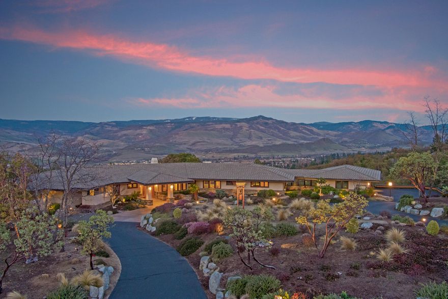 Stunning, multi-million dollar prairie style estate just outside the city limits. 5 private acres w/ meticulous landscaping and endless views of Grizzly Peak, the valley and Pompadour. Over 5,000 SF on the primary level. Maple Floors w/Cherry in-lay. Chef's Dream kitchen with food & butler pantries, 3 ovens, 2 dishwashers, wet & dry bars, full extension and soft close drawers & incredible built-ins. Billiard room w/ balcony access. Media Rm with tray ceiling & media console. Huge master suite with spa bathroom including soaking tub and steam shower. Oversized dressing room. Two main level offices. Lutron lighting system, natural gas, high speed internet and generator back up. 4000 gallons of water storage, multiple storage rooms. Hydronic floor heat and multi-zone heating/cooling systems. Soothing Zen garden, expansive indoor and outdoor entertaining areas. Light filled living room w/ fireplace and incredible wall space for art. Truly a masterpiece that represents an amazing value.