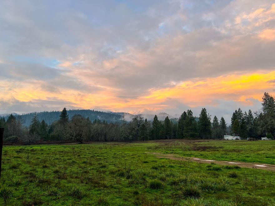 Stunning hard to find 11.43 acres  just north  of Grants Pass.  Well, septic, and electricity are  already there.  Several mature fruit trees, a deer fenced garden, and a seasonal pond are just a few things this very special  private place boasts.  There are two entrances, and all 11.43 acres are fully fenced. The property previously had horses. 
 There are two newer sheds one with a washer and dryer,  the other for storage.   Mountain and tree views from every angle.   Easy access to I-5.  So many possibilities  with this gorgeous space!