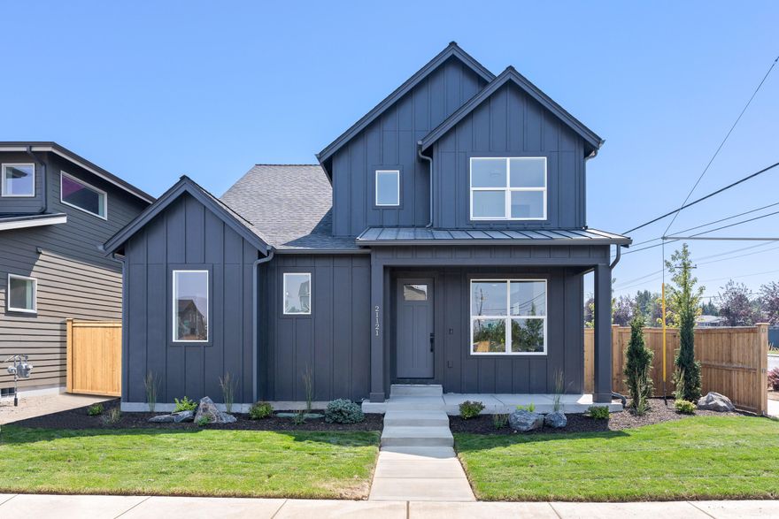 Experience modern farmhouse charm in this newly built home in Sky Vista, crafted by renowned Stone Bridge Homes NW LLC. This 2-story, thoughtfully designed dwelling boasts a primary suite on the main floor for convenient one-level living. The home exudes contemporary elegance with an open-concept living space, highlighted by the eye-catching kitchen. Complete with a center island, ample pantry space, quartz countertops and sleek stainless steel appliances, it is a true entertainers delight. Main level also features a practical mudroom/laundry room off the 2 car garage and access to a covered back patio for seamless indoor-outdoor living. Upstairs houses 3 additional bedrooms, a versatile loft area, an optional den or 5th bedroom for work or relaxation, and a full bath featuring dual vanity for utmost convenience. This picturesque modern farmhouse is perfectly on a corner lot in the desirable Sky Vista community.