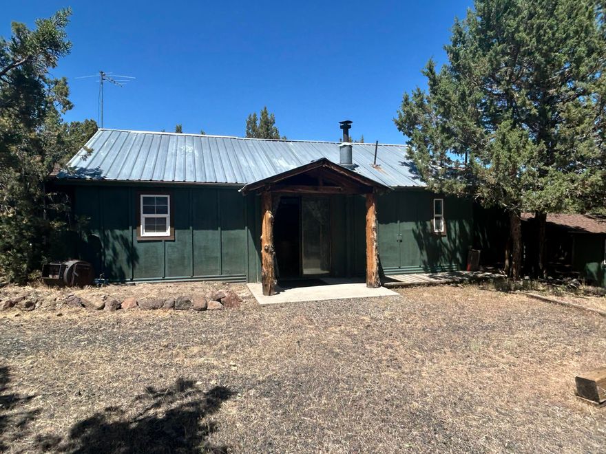 Amazing, Quiet 1.86 Acre Property with Views. Livable Cabin with 2 Bunkhouses, Gazebo with fireplace & Garage/shop. Additional sheds. 1000 gallon concrete septic tank in place with shared well. Nice Views, RV Parking Ready for an updated home or manufactured. County says 3 Bedroom, Cabin is 1 Bedroom plus 2 bunkhouses. Possible Seller Carry with 30% Down Payment. Must See!