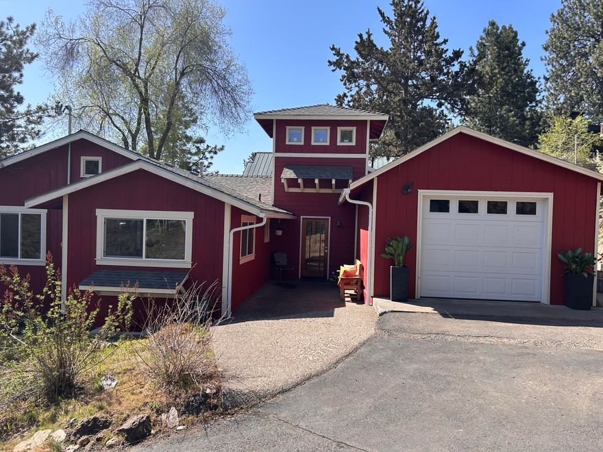 Tucked into the hillside of coveted Awbrey Butte, with a rare expansive lot that is tiered to create usable flat outdoor spaces, this unique property does not front the road but is accessed via passageway behind the main road.  Featuring a lower level separate living space: kitchenette, bedroom and full bath with separate entrance that could be used as guest quarters or mother-in-law suite, this entire property has so much to offer.  The main level features a loft, two spacious bedrooms, and full bath along with an entertainer's kitchen with huge picture windows to highlight the easterly views toward Pilot Butte.  Custom wood and artisan metal details enhance the stylish and distinctive character of the interior, while the abundant outdoor spaces include chicken coop, fenced garden, and lush lawn area for a private west side oasis.  Just a quick jaunt to the river or downtown!