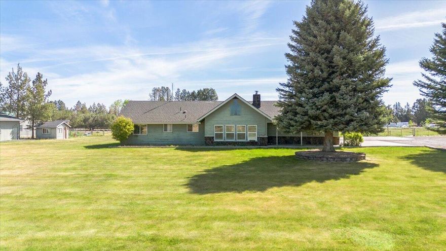 Exquisite 8.92-Acre Estate with Dual Ponds and Water Rights! An outdoor enthusiast's dream, this property offers breathtaking mountain vistas and quintessential ranch-style living. Radiating with natural light, the home boasts updated fixtures, stainless steel appliances, and fresh carpeting. Enhancing the allure, a 1200-square-foot workshop features a cozy pellet stove and ample storage, complemented by a 900-square-foot barn and a dog kennel with an attached shelter. The meticulously landscaped grounds are irrigated, with provisions for boat and RV parking. The property is securely fenced and irrigated for agricultural purposes on its latter portion, all within minutes of town for added convenience. Note: Items in the garage and workshop, such as the car lift, vendor cart, and assorted tools, are not included in the sale.