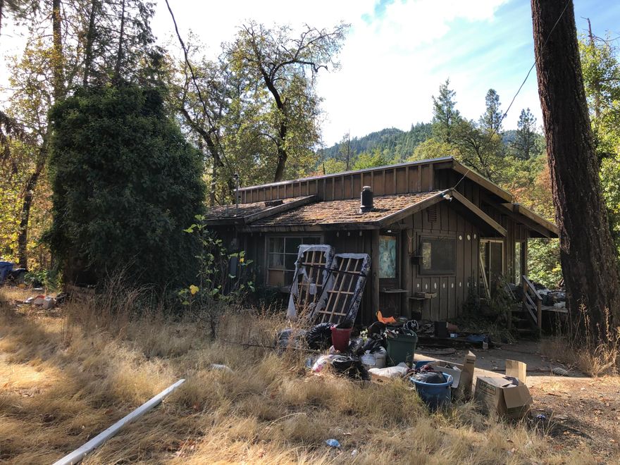 This property could be the Oregon Dream property you've been looking for. It does provide a serene backdrop for your home. This is a great opportunity to fix up this home or have a great home site to build your dream home. With a good clean up, the opportunities are endless.  The property is private, flat to gentle slope to a seasonal creek below. There are mature trees on the property that should be evaluated for safety as part of the buyers due diligence. There are several outbuildings for storage. There is a recent well flow test of 2.9 GPM Average.   The estate will not be making repairs, cleaning up or removing any debris or trees. Buyers to do their own due diligence.