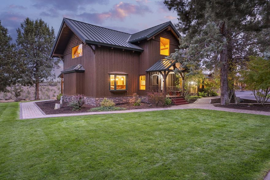 Nestled on the canyon rim, this 20 acre property in the Sisters School District offers a unique custom home built from 100-year-old reclaimed timbers that showcases exceptional craftsmanship in every detail. Centered on a chef's kitchen opening to a grand living room featuring a dramatic floor-to-ceiling stone fireplace. Main level includes a primary suite, office and additional bedroom with ½ bath. Upstairs hosts an open loft and sprawling primary bedroom and bathroom with walk in tile shower and soaking tub. Find the 600 sq ft cottage steps away with full bath and AC. The 2,600 sq ft shop accommodates RVs, hay, and all of your hobbies with a full bath. Equestrian features shine with a 120x118 outdoor arena, round pen, wash rack, trail course, 6 paddocks, and two 12x24 shelters with water and electricity. For your green thumb, there is a greenhouse with fenced in raised beds garden including drip irrigation. A gated serene, versatile estate for family, animals, and outdoor pursuits.