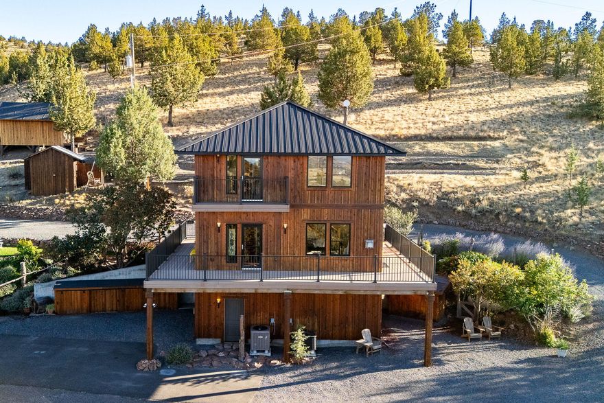 Discover a one-of-a-kind Central Oregon retreat where breathtaking Cascade views, unmatched privacy, & endless adventure meet—perfect as a vacation getaway, peaceful primary residence, or outdoor getaway.  Nestled on 5.04 private acres, this 1,910 sq. ft. custom-built home offers 3 bedrooms, 3 baths, & timeless craftsmanship. Expansive Mill Guard windows and a 360° wrap-around deck frame sunsets over Mt. Jefferson, Hood, Black Butte, Broken Top, and even St. Helens. Adjoining 2,381+ acres of National Grasslands with access to BLM land, the property is ideal for hunting, hiking, horseback riding.  Inside, enjoy hardwood floors, custom woodwork, stainless counters, propane range, and a versatile loft. Outside features include trimmed junipers, fertile soil, a dry sunny climate, and private paved access. Minutes to Haystack Reservoir, Lake Billy Chinook, Smith Rock, Culver, Redmond Airport, and just 45 minutes to Bend. A rare chance to own serenity, recreation, and views that never end.