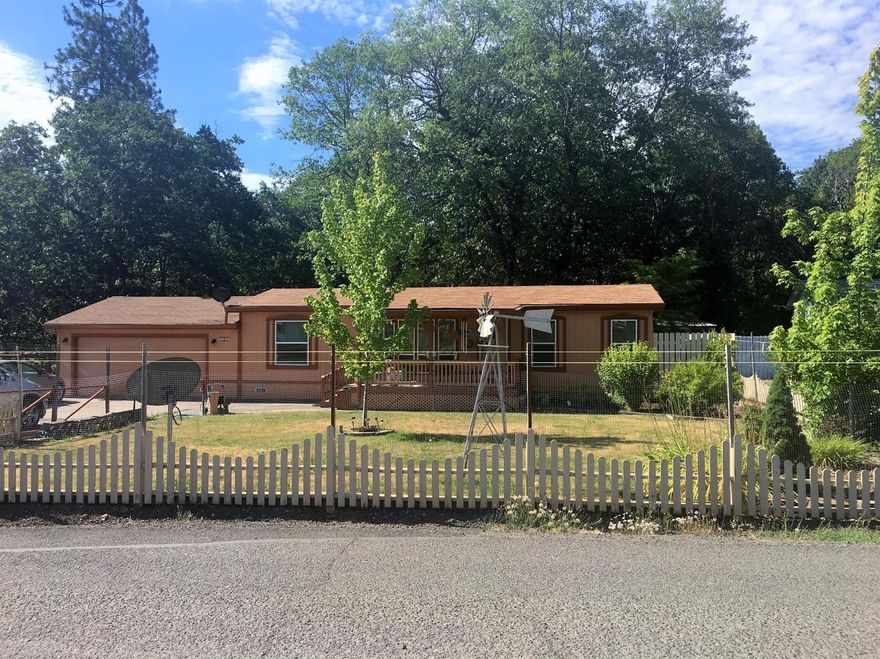 This home has been meticulously cared for and is located on a peaceful & quiet setting in Shady Cove. You will enjoy the privacy the mature trees provide along with the raised garden beds. The kitchen is spacious and has tons of storage including a mud room that exits to the back yard. The home has newer cabinets, flooring and paint. Nice split floor plan with a walk-in shower in the master bedroom and plenty of natural light. The property has a huge garage with a sink along with a smaller detached hobby room in the back yard. There is an abundance of parking available to store your RV's, boats, jet ski's or any other toys you may have. Conveniently located close to the river, shopping and school.