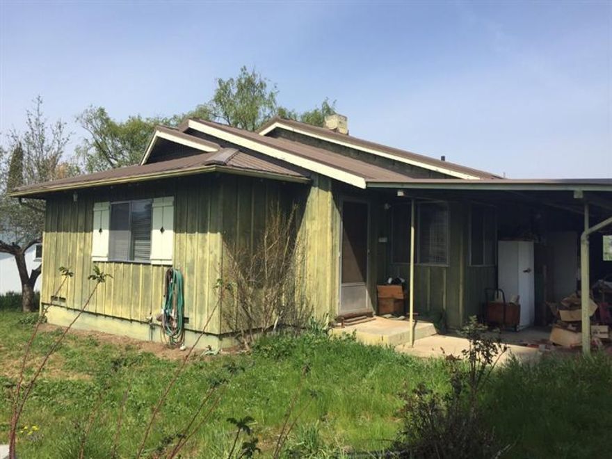 Excellent Rural Opportunity near Ashland. Modest 60's 2/1 1,124sqft ranch home on 1/2 acre with hardwood floors, eat-in kitchen, good built-ins, separate laundry room, well, septic, irrigation rights, good metal roof and detached double garage/shop. Excellent views, great location, Ashland schools. Needs updating, but a perfect project property.