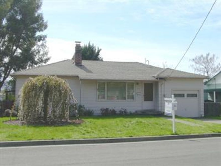 A well-loved home with a comfortable living room with picture window, bright kitchen with eating area, two full bedrooms, and full bathroom with central heating. The garage was partially converted to a laundry, 1/4 bath, loft and storage room. Lot is zoned R2 with a level, fenced backyard. It has a garden storage building (or small shop) and an established garden. In a nicely maintained neighborhood near schools and shopping. All info subject to change; square footage and measurements are approximate.