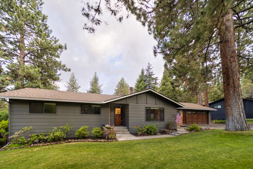 Renovated West Hills single level home on nearly a third of an acre lot with old growth ponderosa pines. Recently painted exterior with red brick accents highlight this traditional North West ranch design. New white oak hardwood floors welcome you into the completely updated, designer done interior. New windows flood the home with natural light. The kitchen includes quartz counters and stainless steel appliances. The cozy living room with wood burning fireplace is great for those cold days but this home is perfect for entertaining when the weather is right. Step outside to the expansive back deck with views of rolling hills. Start the BBQ and break out the games as the fenced in, oversized backyard offers plenty of room to play. Lower level bonus room has exterior access and would be great for a home office, gym, studio, etc.  Newly paved driveway with space for parking a small RV because this is central Oregon. Location gets an A+, just blocks from Hillside Park and shops on Newport